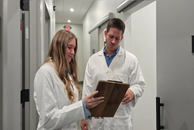 Home 45 Chiropractors reviewing patient records together at Chiro Life Wellness.