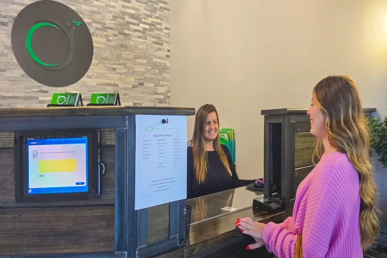 Home 41 Patient checking in at the reception desk at Chiro Life Wellness.