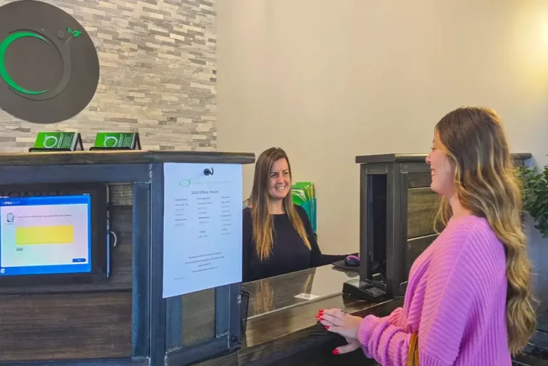Home 40 Patient checking in at the reception desk at ChiroLife Wellness.